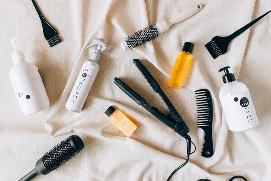 Productos y herramientas para el cuidado de la barba sobre una tela con textura.