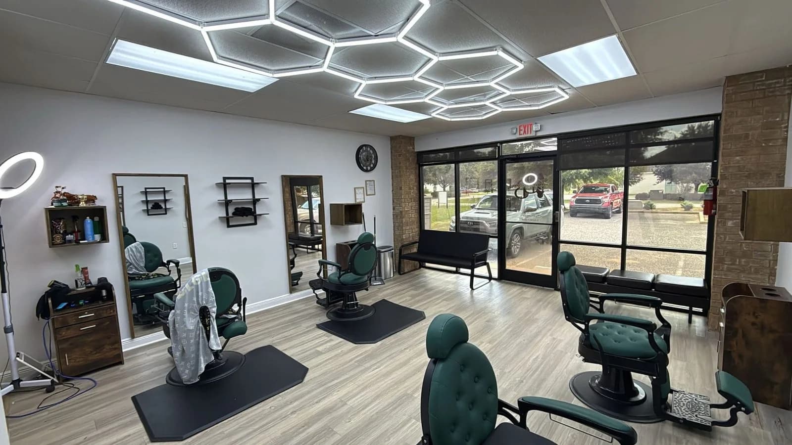 Blessed Barbershop interior — green barber chairs and hexagon lighting, Daphne AL