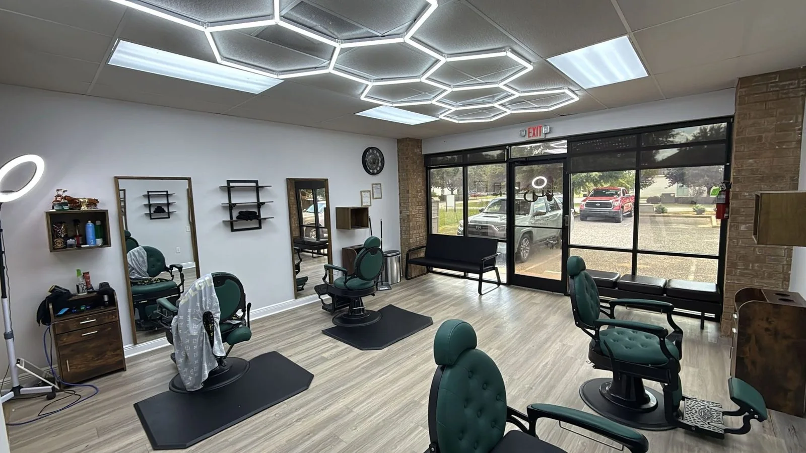 Blessed Barbershop interior — green barber chairs and hexagon lighting, Daphne AL
